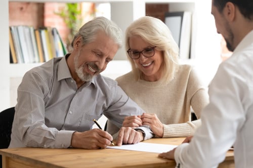 couple signing loan paperwork